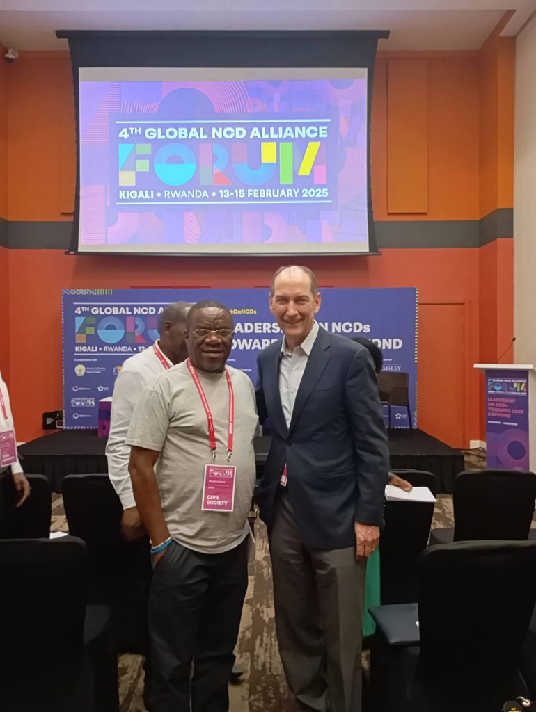 John Gikonyo with a delegate at the NCD forum in Kigali