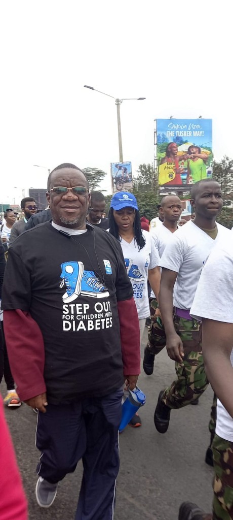 John Gikonyo walking in a city health procession